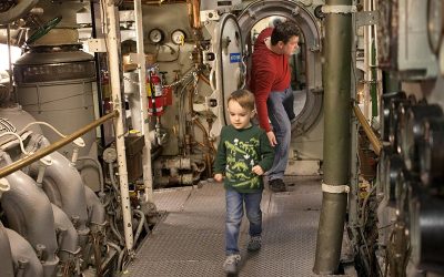 Father and son walking through Submarine Becuna at The Independence Seaport Museum